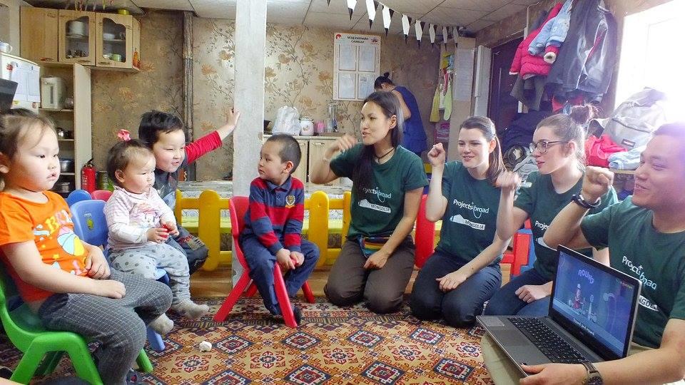 Projects Abroad Childcare volunteers in Mongolia teach a hygiene workshop showing young children how to brush their teeth. A group of female volunteers working with children in Mongolia demonstrate personal hygiene at a care centre.